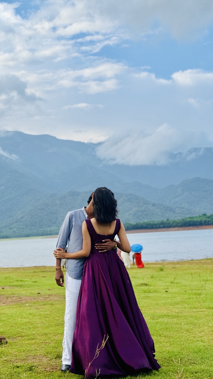 Us embracing beside a lake and mountains